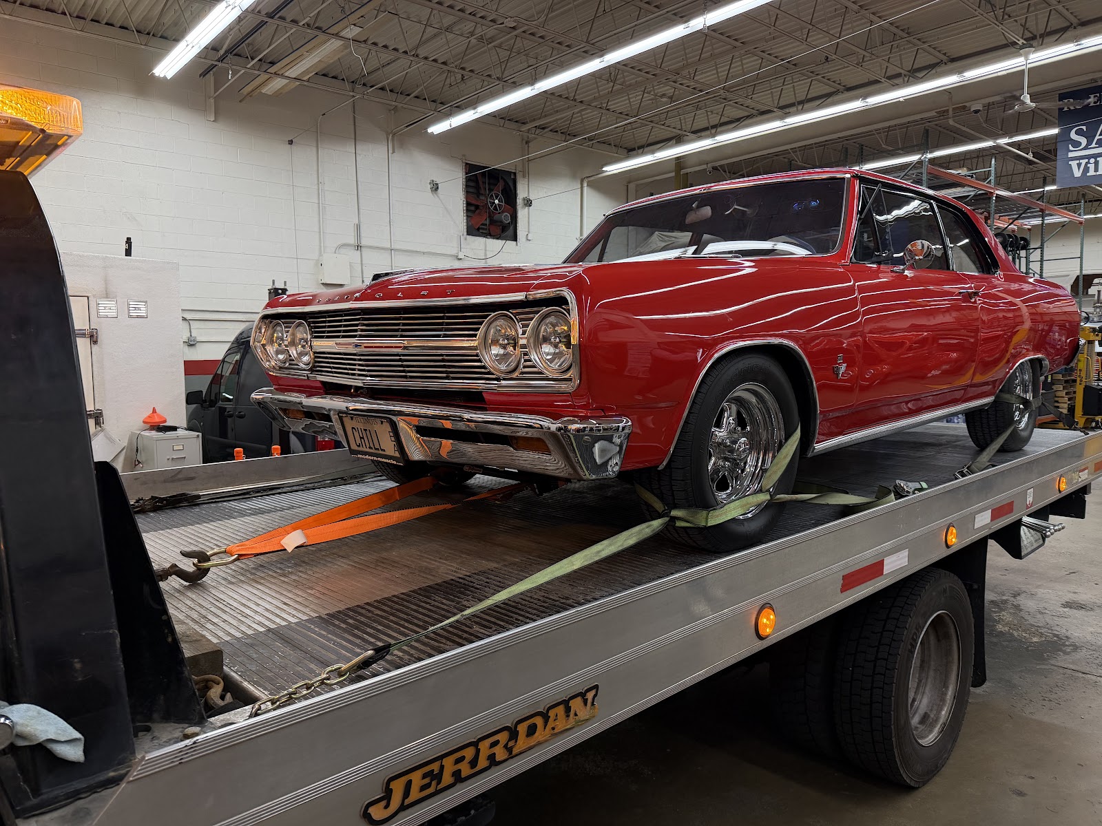 Red classic car being transported